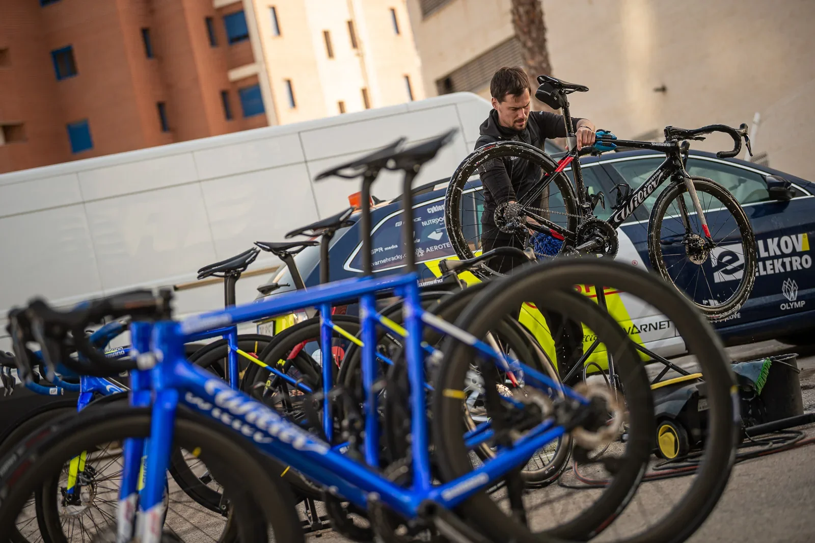 František Sisr preparing racing bikes beside the Kasper C4M team vehicle