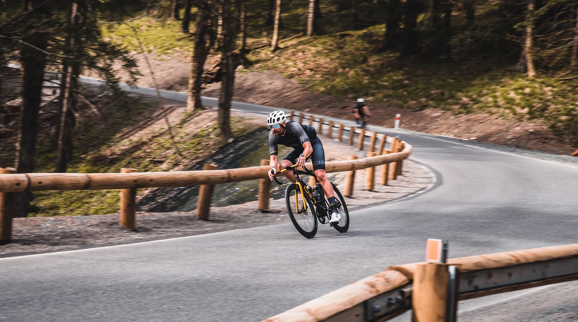 Rider on an IDEA road bike in a forest corner