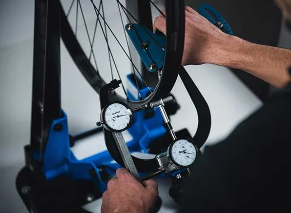 A wheelset being measured and checked by hand in the workshop