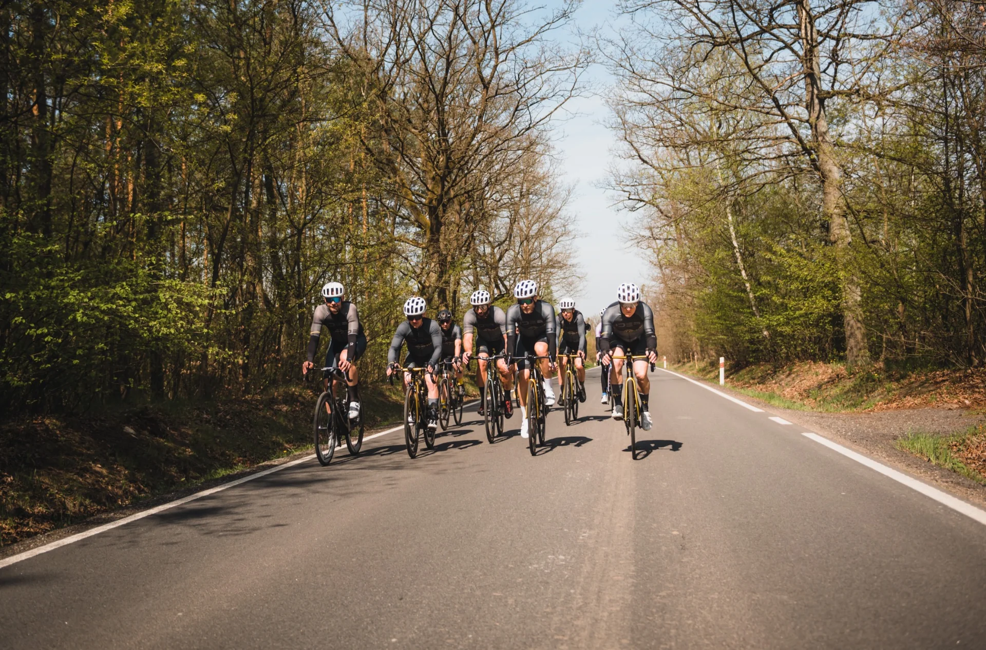 The Rafkarna IDEA Cycling Team peloton training together on a forest road